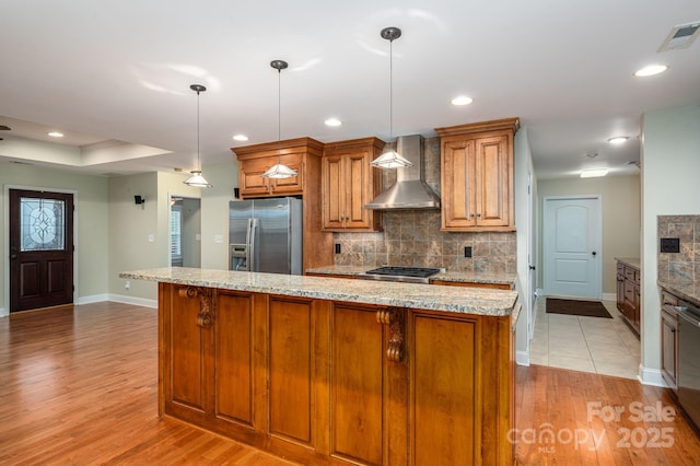 2817 Long Cir Unit 1, Iron Station, NC 28080 - kitchen with stainless steel appliances, wall chimney range hood, baseboards, light wood finished floors, and recessed lighting