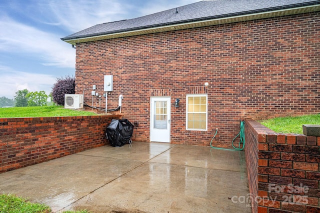 2817 Long Cir Unit 1, Iron Station, NC 28080 - rear view of property featuring a patio, brick siding, a cooling unit, and roof with shingles