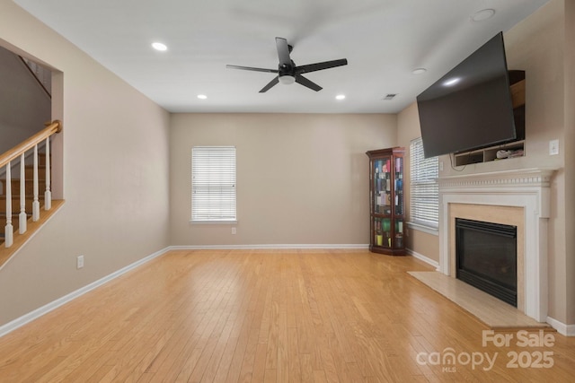 4764 Brockton Ct NW, Concord, NC 28027 - unfurnished living room featuring stairway, ceiling fan, a high end fireplace, healthy amount of natural light, and recessed lighting