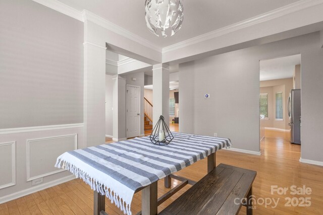 4764 Brockton Ct NW, Concord, NC 28027 - bedroom featuring freestanding refrigerator, light wood-style floors, a chandelier, crown molding, and baseboards