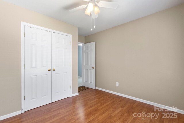 4764 Brockton Ct NW, Concord, NC 28027 - unfurnished bedroom featuring wood finished floors, baseboards, and a closet