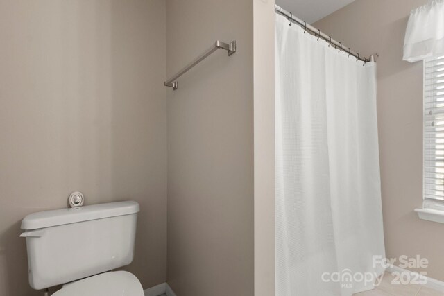 4764 Brockton Ct NW, Concord, NC 28027 - full bathroom featuring toilet, a shower with shower curtain, tile patterned floors, and baseboards