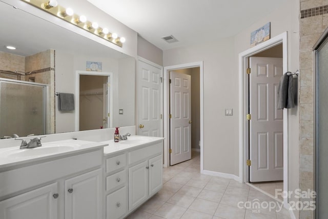 4764 Brockton Ct NW, Concord, NC 28027 - bathroom with a stall shower, double vanity, tile patterned floors, and a walk in closet