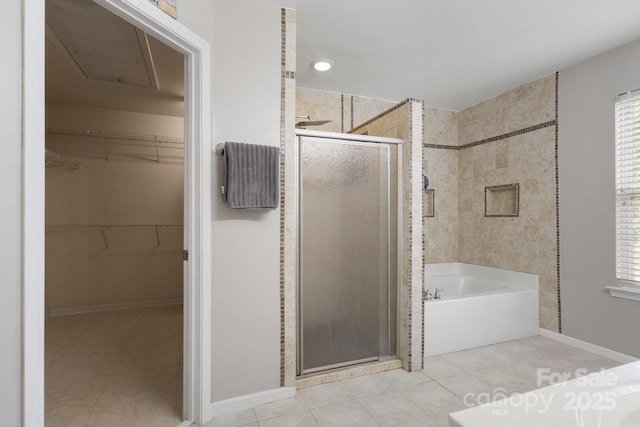 4764 Brockton Ct NW, Concord, NC 28027 - bathroom featuring a stall shower, a bath, a spacious closet, and baseboards