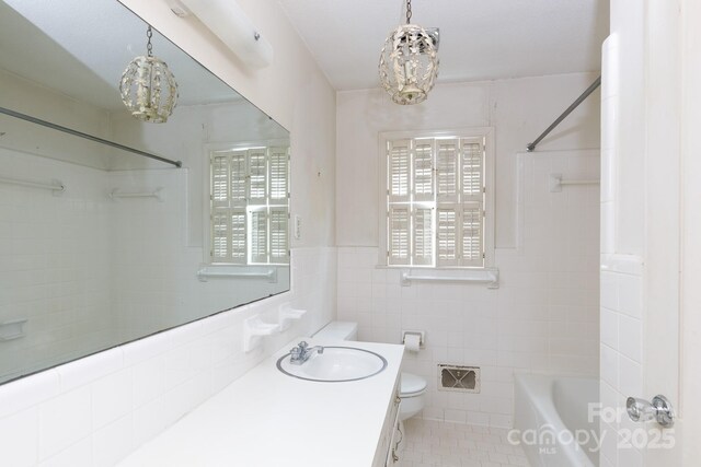761 Milton Ave, Rock Hill, SC 29730 - full bathroom featuring a chandelier, toilet, tile walls, vanity, and tile patterned floors