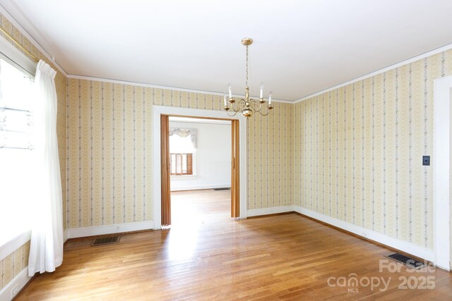761 Milton Ave, Rock Hill, SC 29730 - unfurnished dining area featuring wood finished floors, a chandelier, baseboards, and crown molding