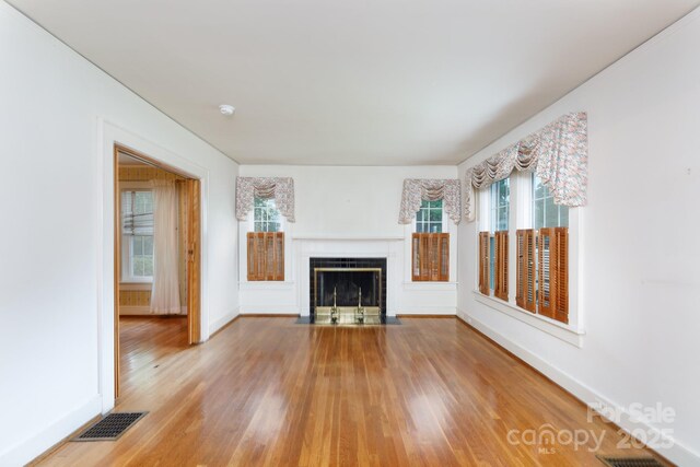 761 Milton Ave, Rock Hill, SC 29730 - unfurnished living room featuring wood finished floors, baseboards, and a fireplace with flush hearth