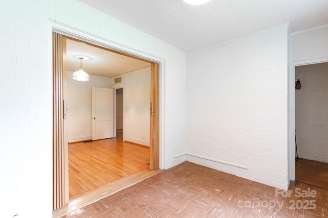761 Milton Ave, Rock Hill, SC 29730 - unfurnished room featuring brick wall, baseboards, and parquet flooring
