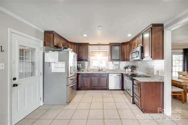 739 Springdale Rd, Rock Hill, SC 29730 - kitchen featuring appliances with stainless steel finishes, tasteful backsplash, crown molding, light tile patterned floors, and light stone counters