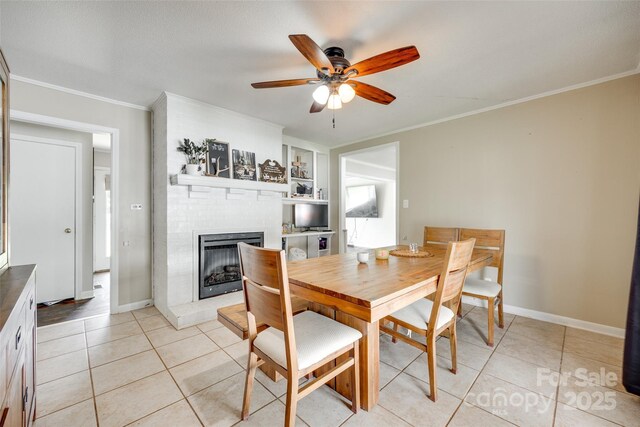 739 Springdale Rd, Rock Hill, SC 29730 - dining space with a fireplace, a ceiling fan, built in shelves, ornamental molding, and light tile patterned flooring
