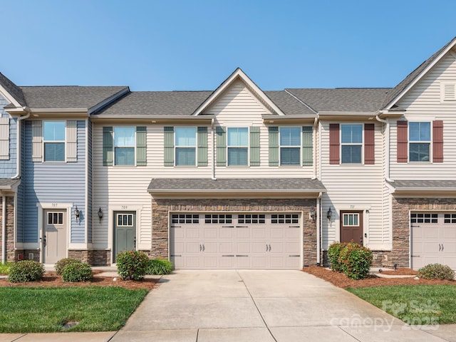 709 Volta Dr NW, Concord, NC 28027 - view of property featuring stone siding, an attached garage, and concrete driveway