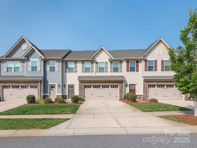 709 Volta Dr NW, Concord, NC 28027 - townhome / multi-family property featuring a garage, stone siding, and driveway