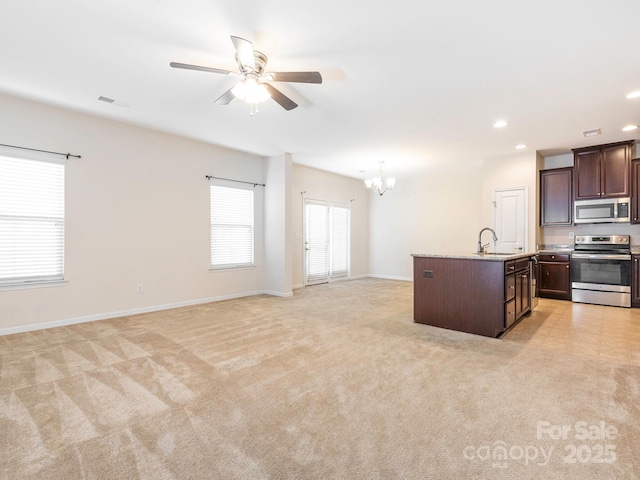 709 Volta Dr NW, Concord, NC 28027 - kitchen with appliances with stainless steel finishes, a chandelier, dark brown cabinets, ceiling fan, and a sink