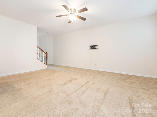 709 Volta Dr NW, Concord, NC 28027 - empty room featuring ceiling fan, light carpet, baseboards, and stairs