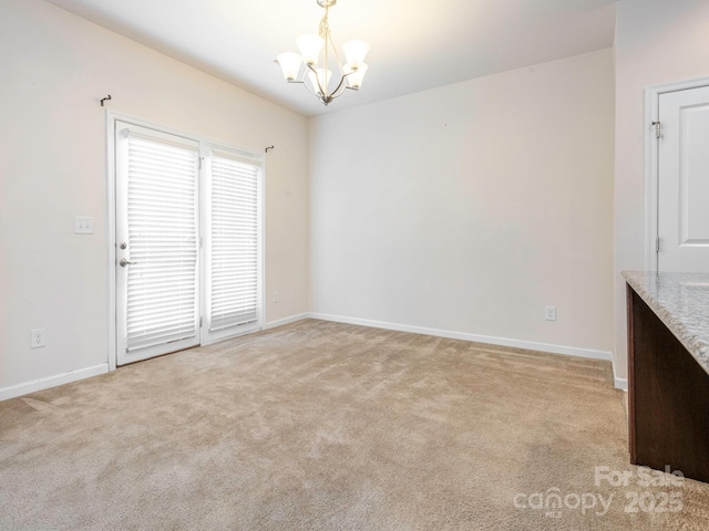 709 Volta Dr NW, Concord, NC 28027 - unfurnished dining area featuring a chandelier, light colored carpet, and baseboards