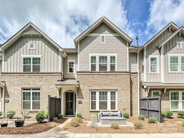 10022 Wayfair Meadow Ct, Charlotte, NC 28277 - view of property featuring board and batten siding, brick siding, and an outdoor living space