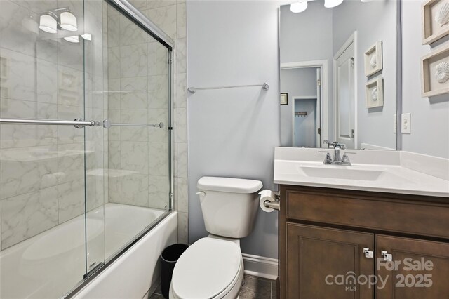 10022 Wayfair Meadow Ct, Charlotte, NC 28277 - full bathroom featuring toilet, vanity, combined bath / shower with glass door, and baseboards