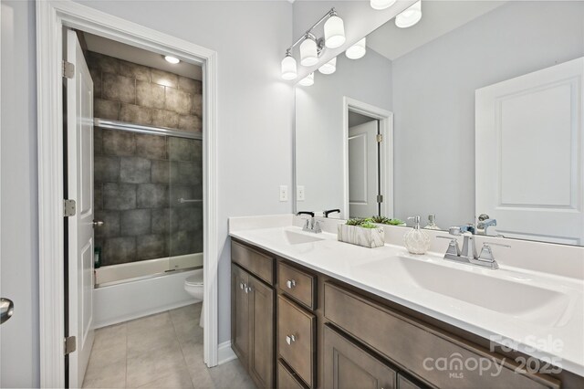 10022 Wayfair Meadow Ct, Charlotte, NC 28277 - bathroom with toilet, double vanity, tile patterned floors, and combined bath / shower with glass door