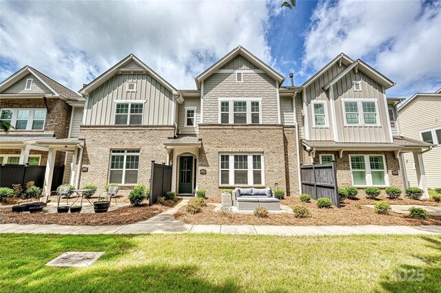 10022 Wayfair Meadow Ct, Charlotte, NC 28277 - view of front of home with an outdoor living space, board and batten siding, brick siding, and a patio