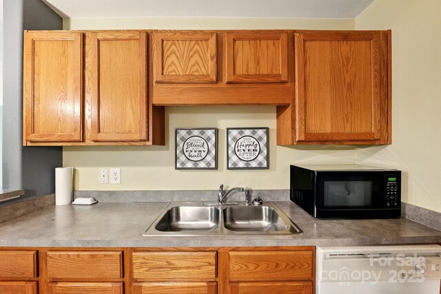1134 Plaza Walk Dr, Charlotte, NC 28215 - kitchen with black microwave, a sink, white dishwasher, and light countertops