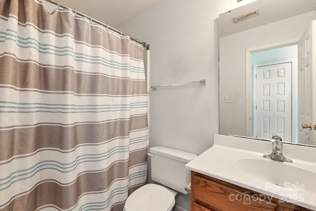 1134 Plaza Walk Dr, Charlotte, NC 28215 - full bathroom with toilet, vanity, and a shower with curtain
