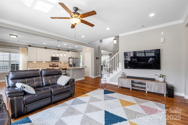 12312 Mcallister Park Dr, Charlotte, NC 28277 - living room featuring a ceiling fan, dark wood-style floors, crown molding, baseboards, and stairway