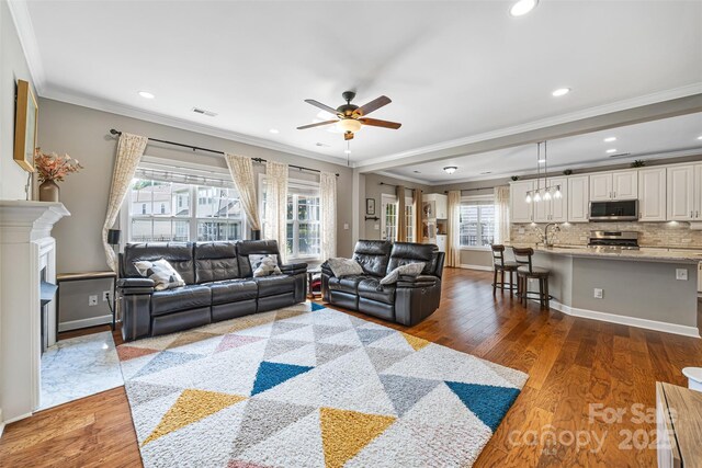 12312 Mcallister Park Dr, Charlotte, NC 28277 - living area with a ceiling fan, crown molding, wood finished floors, recessed lighting, and baseboards