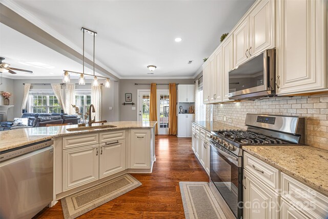 12312 Mcallister Park Dr, Charlotte, NC 28277 - kitchen featuring appliances with stainless steel finishes, a sink, dark wood finished floors, open floor plan, and backsplash