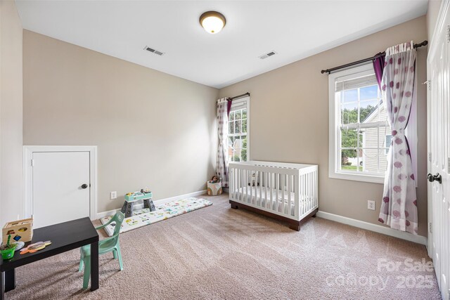 12312 Mcallister Park Dr, Charlotte, NC 28277 - carpeted bedroom featuring baseboards and a nursery area