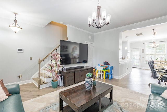 5623 Fetzer Ave NW, Concord, NC 28027 - living area with a chandelier, ornamental molding, light wood-type flooring, and stairs