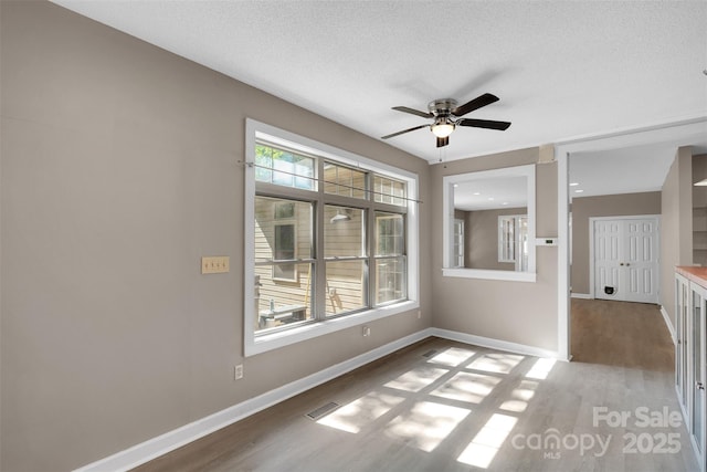 3333 Roberta Rd, Concord, NC 28027 - unfurnished room with wood finished floors, ceiling fan, and a textured ceiling