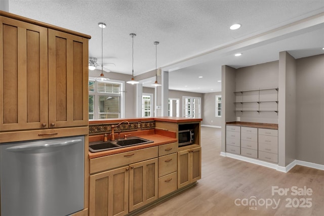 3333 Roberta Rd, Concord, NC 28027 - kitchen with stainless steel appliances, light wood-style floors, hanging light fixtures, a peninsula, and brown cabinetry