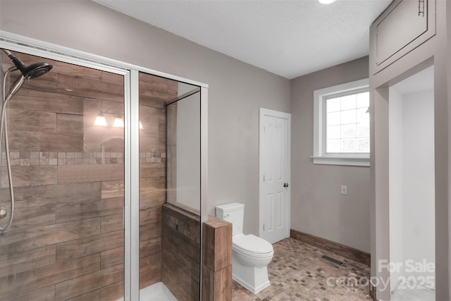 3333 Roberta Rd, Concord, NC 28027 - bathroom featuring a shower stall and a textured ceiling