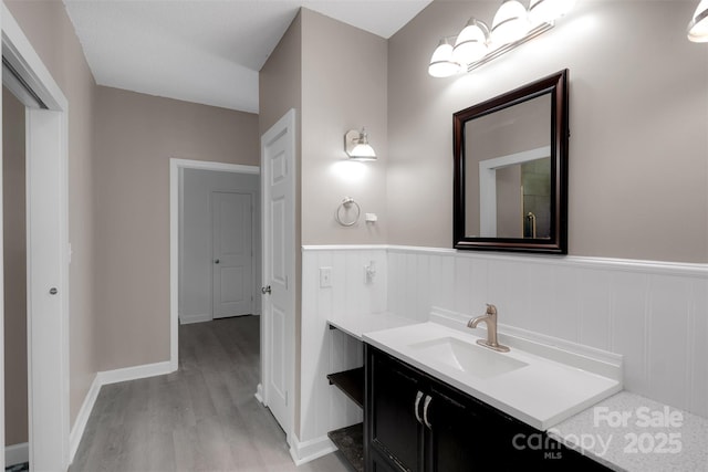 3333 Roberta Rd, Concord, NC 28027 - bathroom with wood finished floors, vanity, and a wainscoted wall