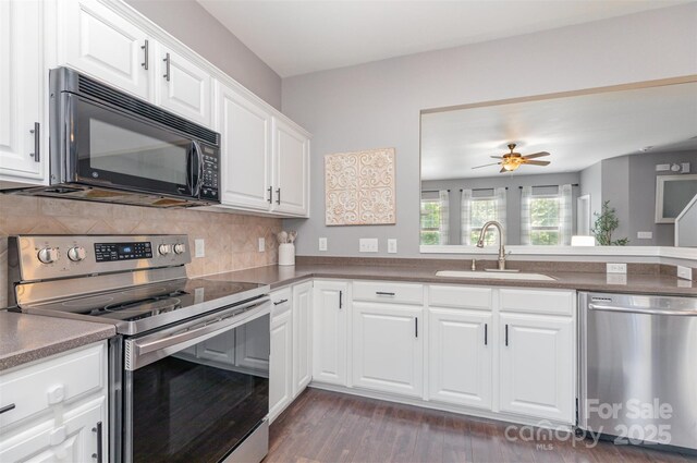 2945 Duvalla Ave, Charlotte, NC 28209 - kitchen featuring stainless steel appliances, dark wood-style flooring, tasteful backsplash, white cabinetry, and a ceiling fan