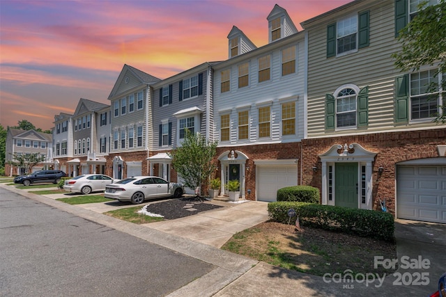2945 Duvalla Ave, Charlotte, NC 28209 - townhome / multi-family property featuring an attached garage, a residential view, concrete driveway, and brick siding