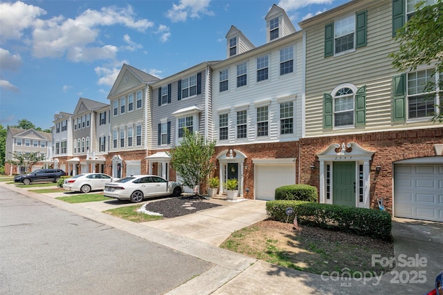 2945 Duvalla Ave, Charlotte, NC 28209 - multi unit property with a residential view, brick siding, an attached garage, and concrete driveway