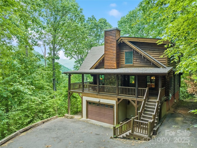 536 Tawodi Trl, Maggie Valley, NC 28751 - view of front of property featuring asphalt driveway, roof with shingles, an attached garage, stairs, and a chimney