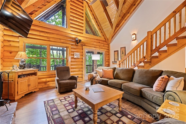 536 Tawodi Trl, Maggie Valley, NC 28751 - living room with rustic walls, light wood finished floors, high vaulted ceiling, wooden ceiling with exposed beams, and stairs