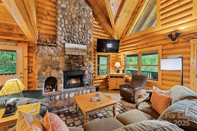 536 Tawodi Trl, Maggie Valley, NC 28751 - living area with hardwood / wood-style flooring, a fireplace, wooden ceiling with exposed beams, rustic walls, and high vaulted ceiling