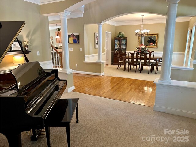 155 Culpeze Rd, Mooresville, NC 28117 - living area featuring carpet, ornamental molding, arched walkways, wood finished floors, and decorative columns