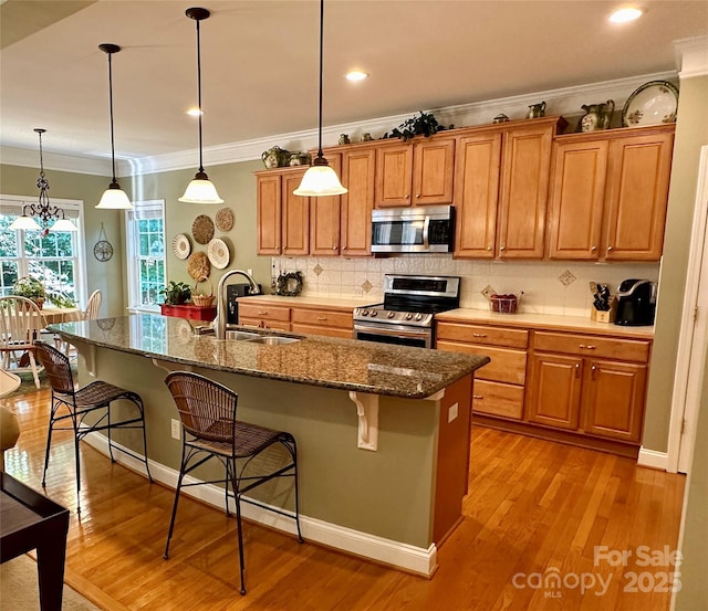 155 Culpeze Rd, Mooresville, NC 28117 - kitchen with appliances with stainless steel finishes, a kitchen breakfast bar, crown molding, brown cabinetry, and backsplash