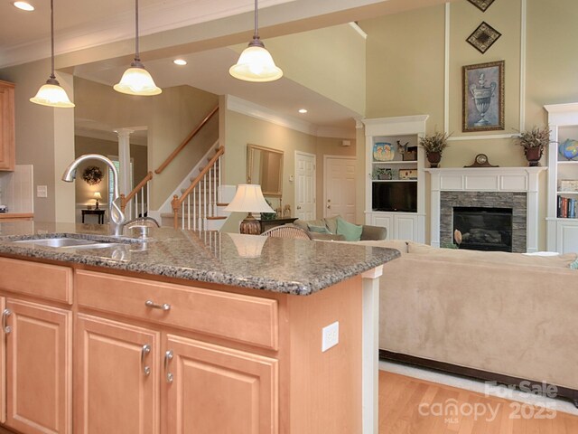 155 Culpeze Rd, Mooresville, NC 28117 - kitchen featuring crown molding, stone counters, light wood finished floors, a fireplace, and recessed lighting