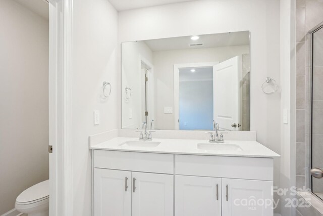 1730 Old Rivers Rd, Concord, NC 28027 - bathroom featuring double vanity, tiled shower, toilet, and recessed lighting