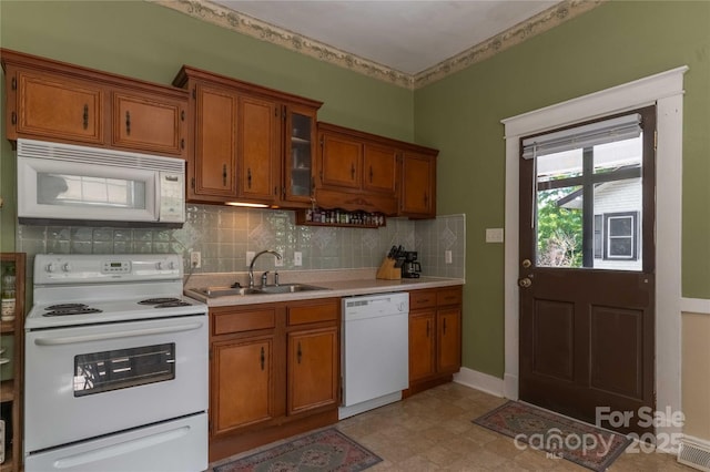 6 Wood Ave, Asheville, NC 28803 - kitchen featuring white appliances, brown cabinetry, light countertops, and decorative backsplash