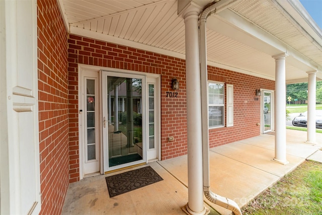 7012 Somerset Springs Dr Unit E, Charlotte, NC 28262 - doorway to property with covered porch and brick siding
