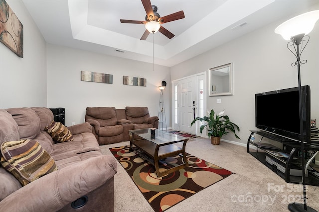 7012 Somerset Springs Dr Unit E, Charlotte, NC 28262 - carpeted living room featuring a ceiling fan and a tray ceiling