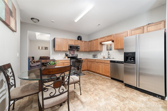 7012 Somerset Springs Dr Unit E, Charlotte, NC 28262 - kitchen featuring appliances with stainless steel finishes, light countertops, stone finish flooring, and light brown cabinets