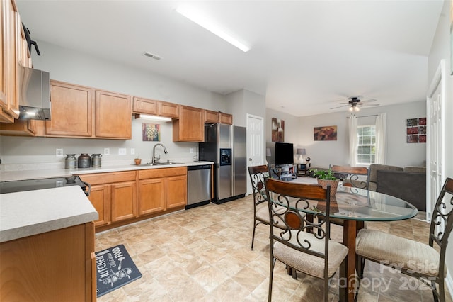 7012 Somerset Springs Dr Unit E, Charlotte, NC 28262 - kitchen with appliances with stainless steel finishes, light countertops, a ceiling fan, and stone finish floors