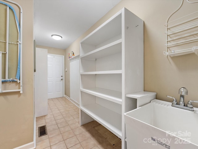 5104 Top Seed Ct, Charlotte, NC 28226 - laundry area featuring a sink and tile patterned floors